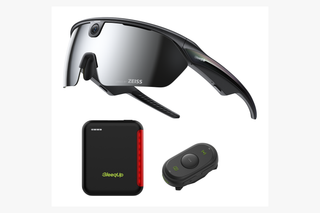 Cycling accessories laid out together including camera glasses and a controller