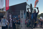 Trials rider inverted above the landing airbag at the peak of a backflip
