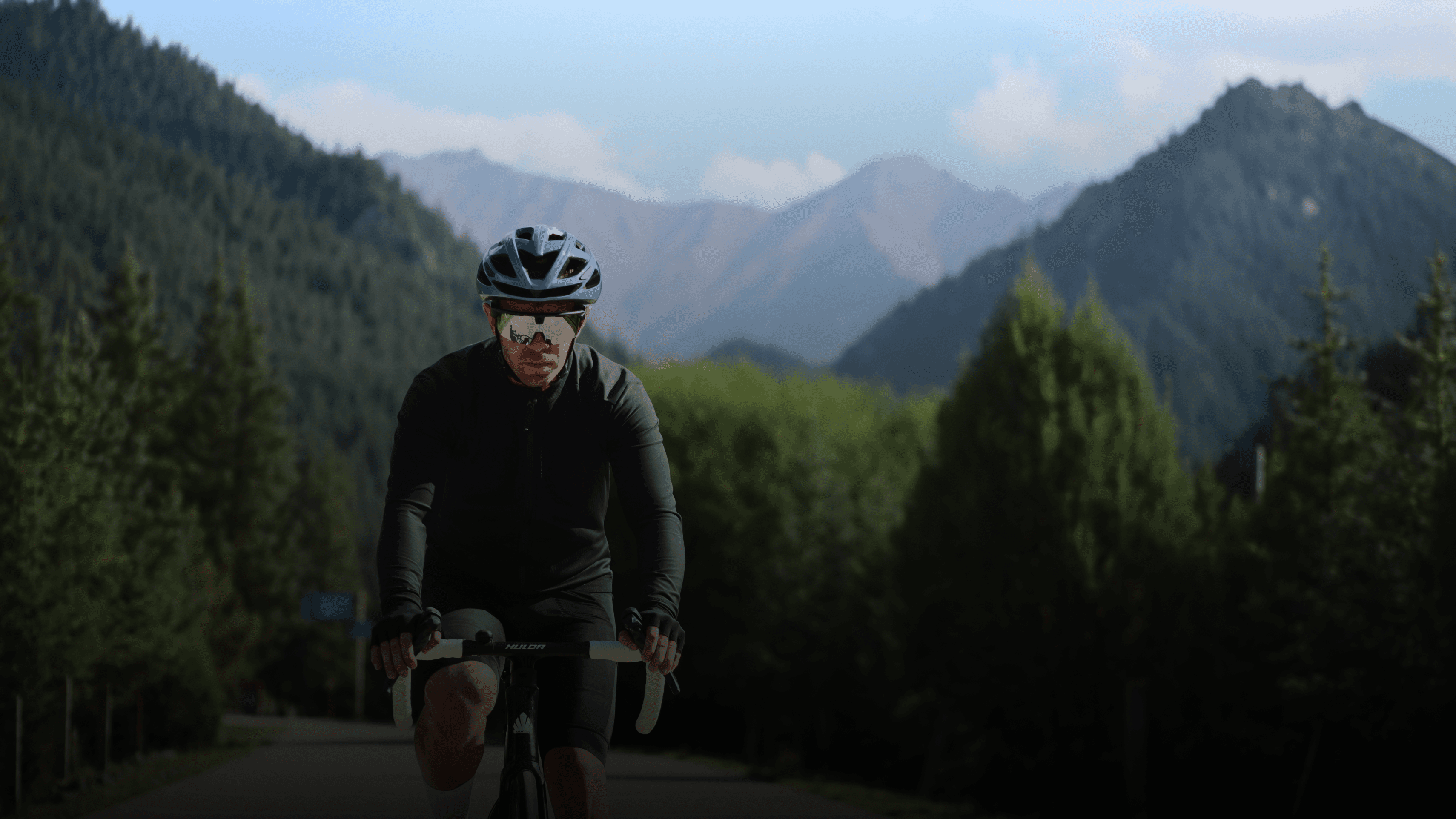 Cyclist riding through mountain roads in the BleeqUp Rover campaign